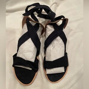 Anaki black suede sandals with gold detail in back